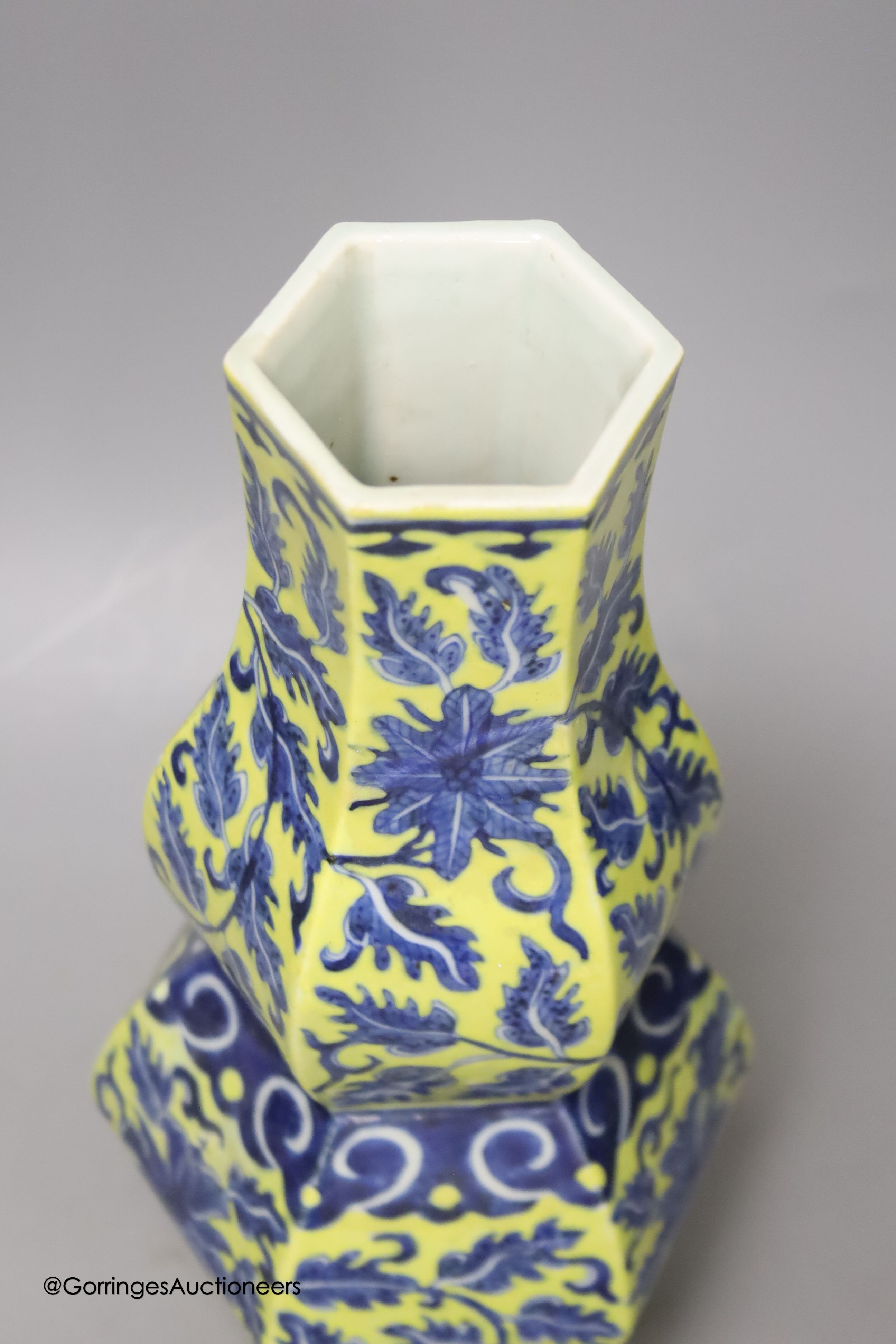 A Chinese underglaze blue yellow ground hexagonal vase, early 20th century, some restoration 35cm